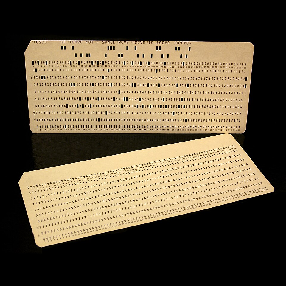 Historical 80-column IBM punch cards used for early computer programming.